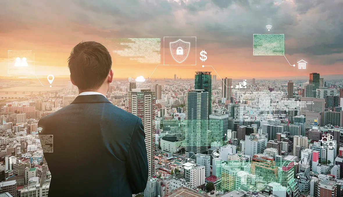 Man in a suit looking over a city skyline overlaid with data and property icons